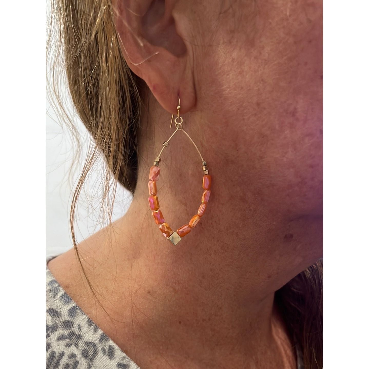 Gold teardrop beaded earrings. Coral