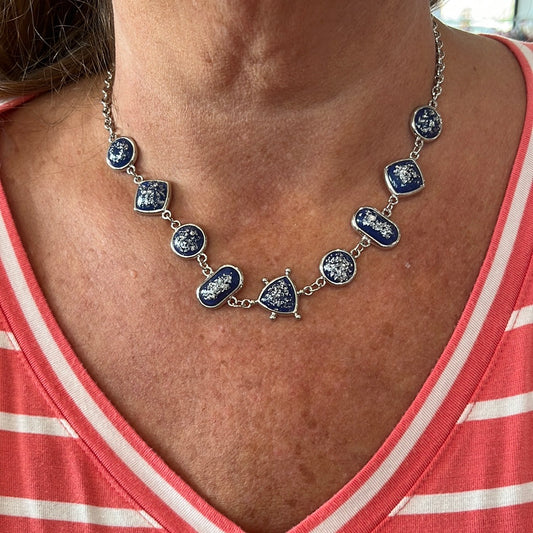 Silver chain with dark blue and silver necklace. 