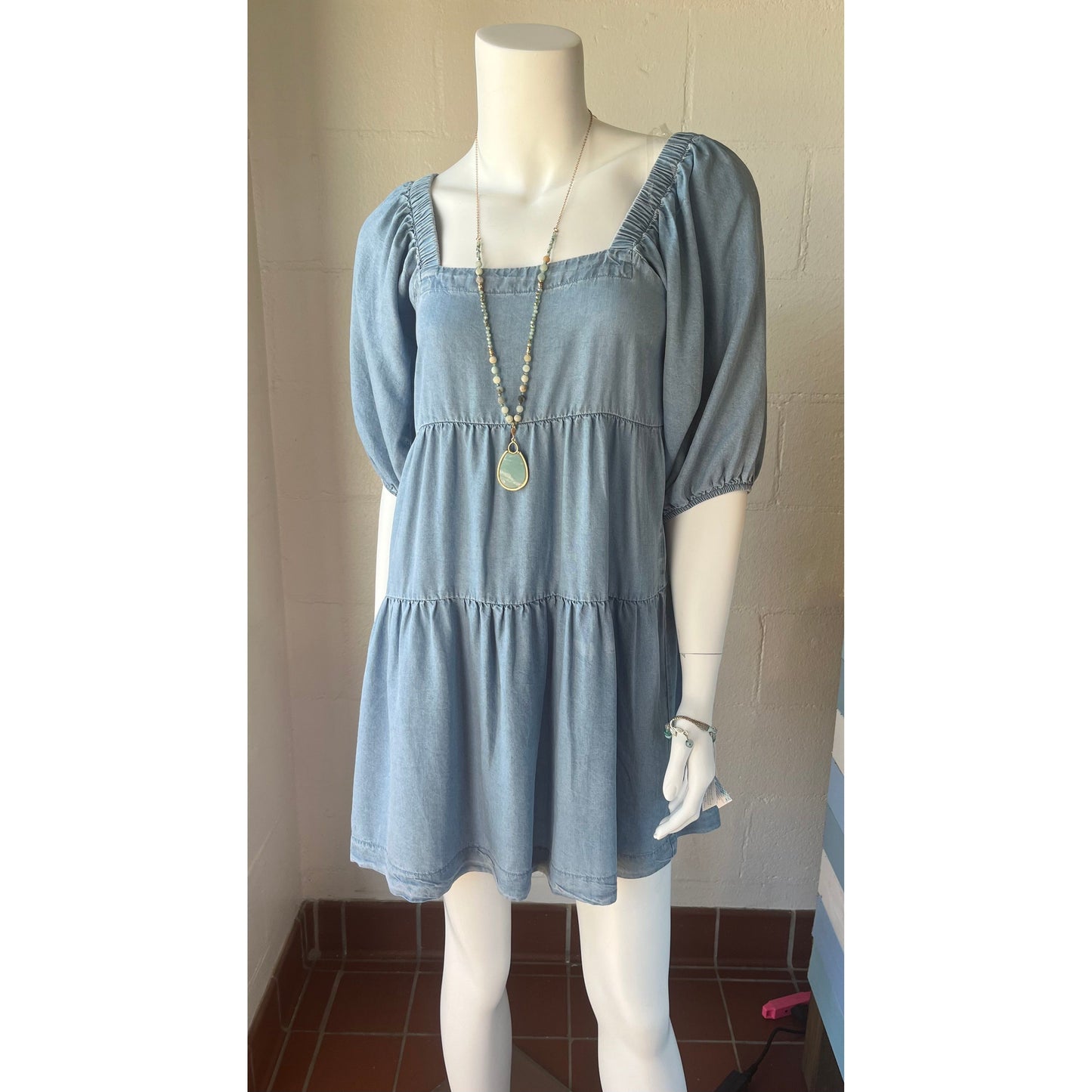 Denim Tencel Tiered Dress with Puff Sleeves by Hunter Brown.  Available in sizes X-Small through Large.  100% Lyocell
