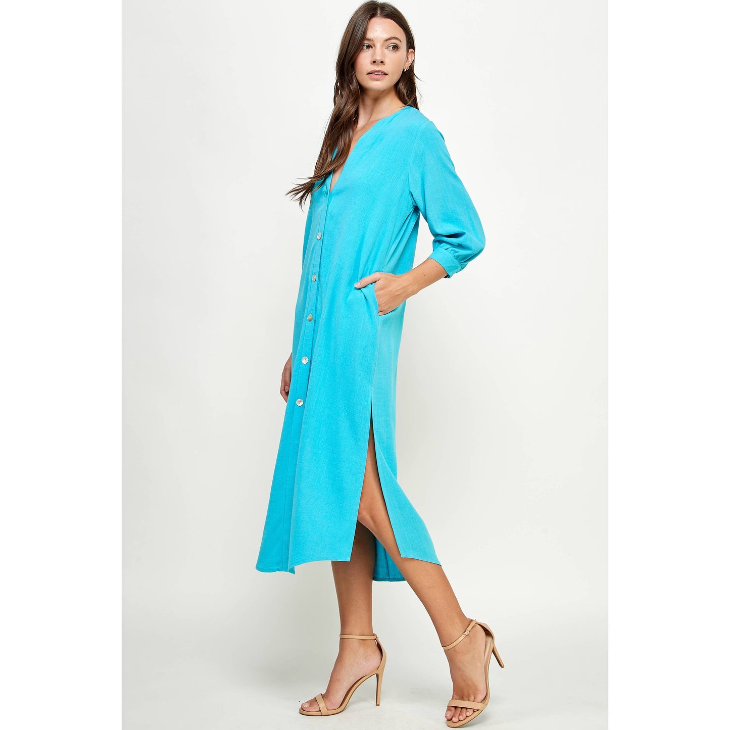 Teal v-neck button down dress with 3/4 sleeves. Dress is mid-calf length