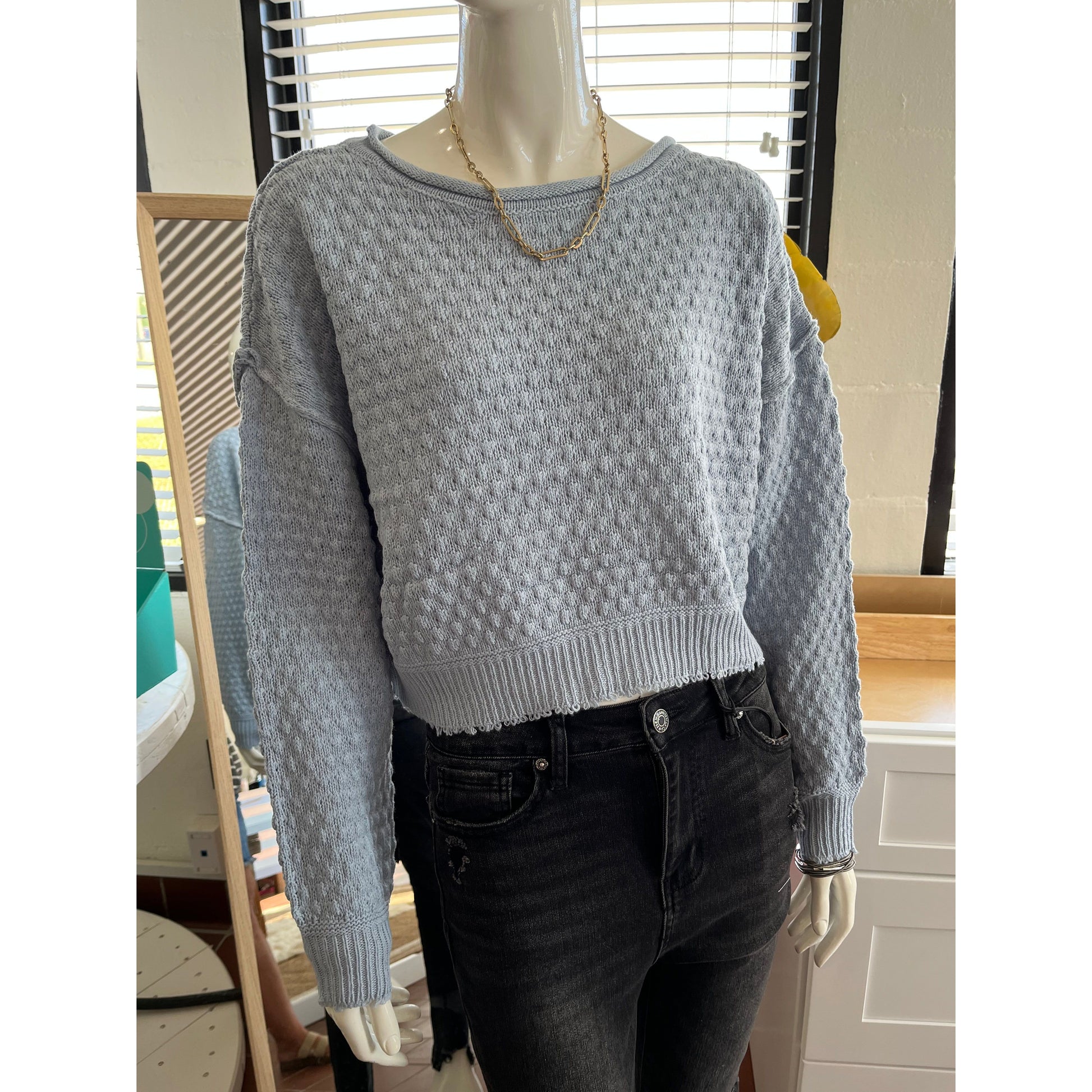 Long sleeve cropped, blue sweater.  60% Cotton, 40% Acrylic. Available in Medium and Large