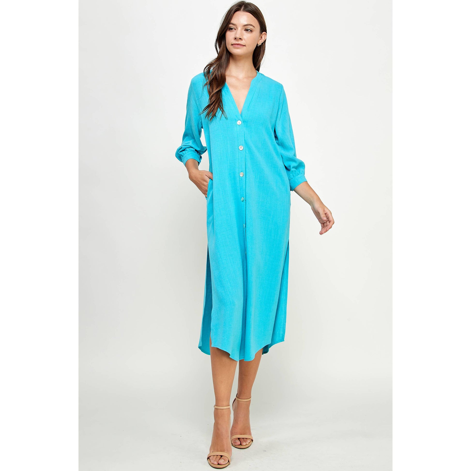 Blue V-Neck Button Down Linen Dress by Ellison Apparel. Available in sizes Small through Large. 70% Viscose, 30% Linen.