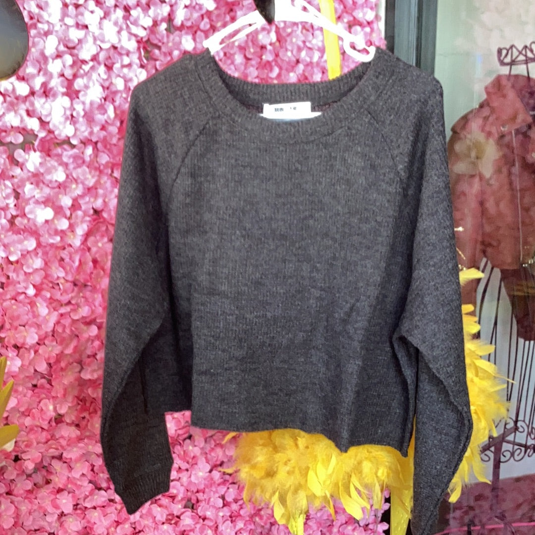 Cropped lightweight sweater, available in sizes Small through Large. 85% Polyester, 15% Rayon. Black