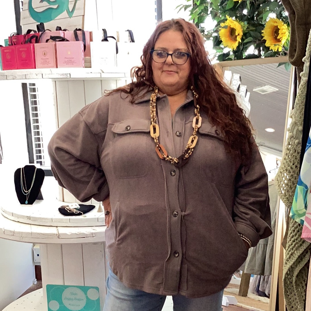 cool gray toned brown button up jacket with collar, metal button close pockets on both sides on the chest area. Two slit pockets are on the front bottom panels of the jacket. Available in sizes 1X-3X. 95% Polyester, 5% Spandex. Brand: Sweet Lovely by Jen